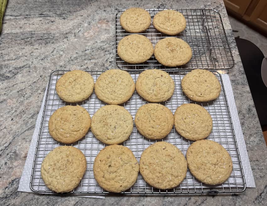 16 delicious almond sugar cookies, on a wire rack, on a granite countertop